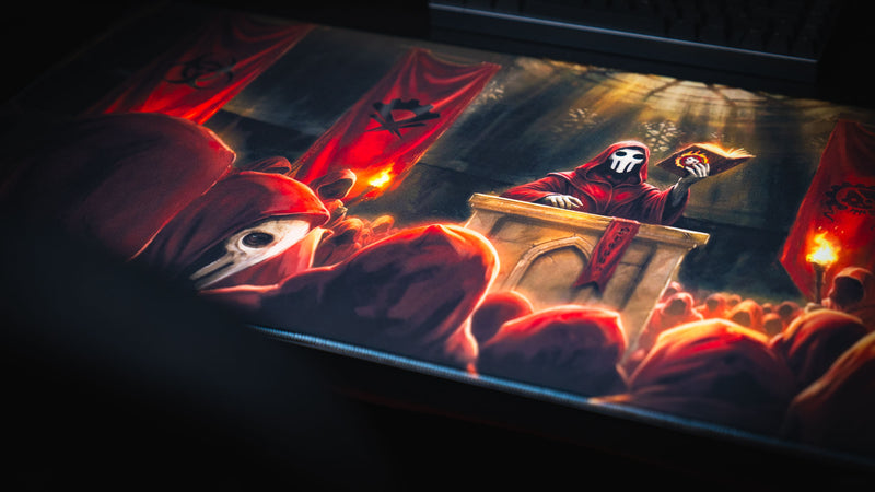 Close-up of the Pravus Crimson Convocation deskmat highlighting the masked cult leader preaching from a podium before a crowd beneath glowing crimson banners.