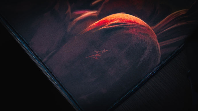 Close-up of precision stitching along a deskmat edge