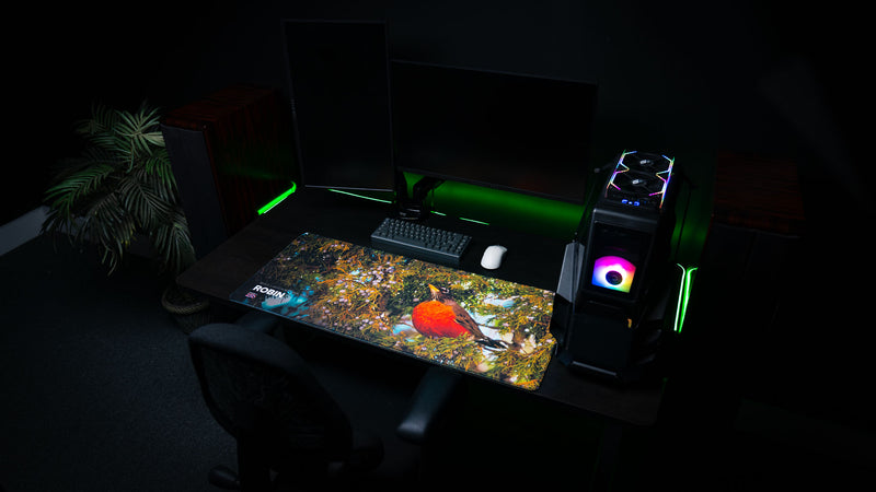 Robin wildlife deskmat displayed in a modern gaming setup, featuring a vibrant American robin perched in juniper branches from Bryce Canyon National Park on a premium extended mouse pad.