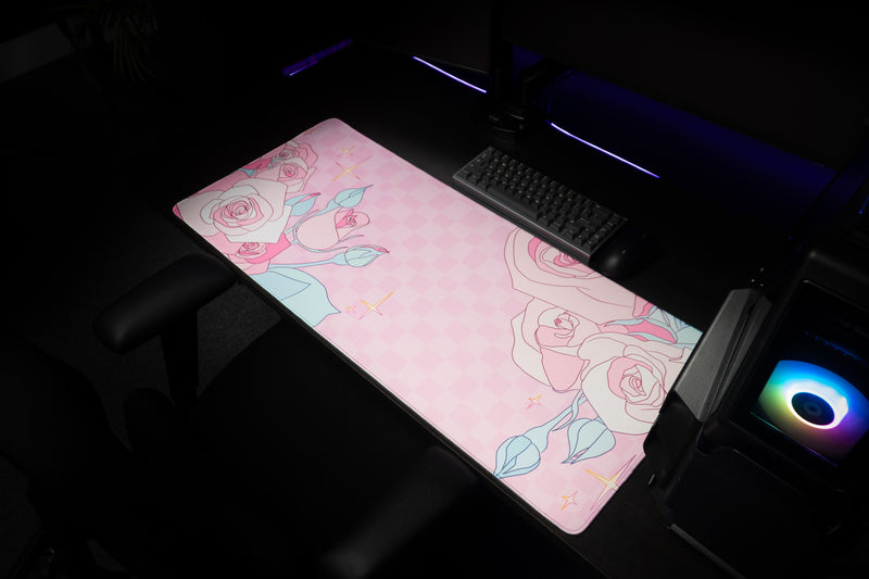 Wide workstation view of Rosy Racer's Full Bloom desk mat beneath a keyboard.