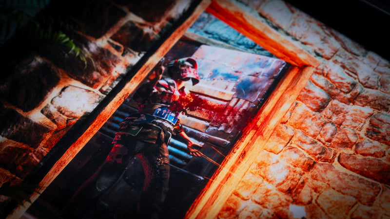Close-up of The Doorcamper / Angle 2 Rust deskmat featuring an intense firefight through a stone base doorway, with vivid lighting, detailed textures, and premium-quality printed artwork.