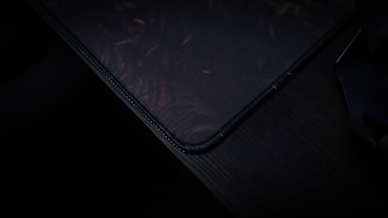 Close-up of The Doorcamper / Angle 2 Rust deskmat showcasing premium stitched edges, durable cloth surface, and high-quality craftsmanship designed for long-lasting gaming performance.