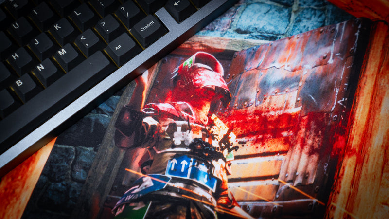 Close-up of The Doorcamper / Angle 3 Rust deskmat featuring an armored defender caught in an intense doorway firefight, showcasing vivid colors, detailed textures, and premium-quality printed artwork.