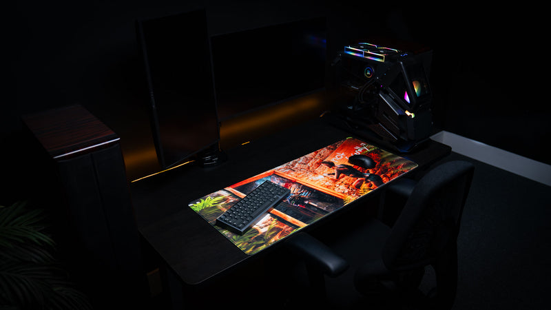 Wide-angle gaming setup featuring The Doorcamper / Angle 3 Rust deskmat on a modern desk with mechanical keyboard, gaming mouse, and RGB PC, highlighting the immersive artwork and extended XL surface.