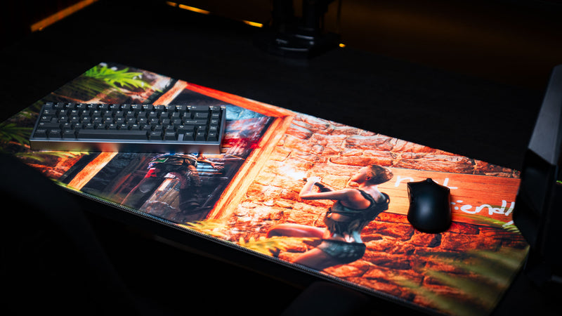 Angled view of The Doorcamper / Angle 3 Rust deskmat with a mechanical keyboard and gaming mouse, highlighting the detailed raid scene, premium stitched edges, and vibrant full-color print.