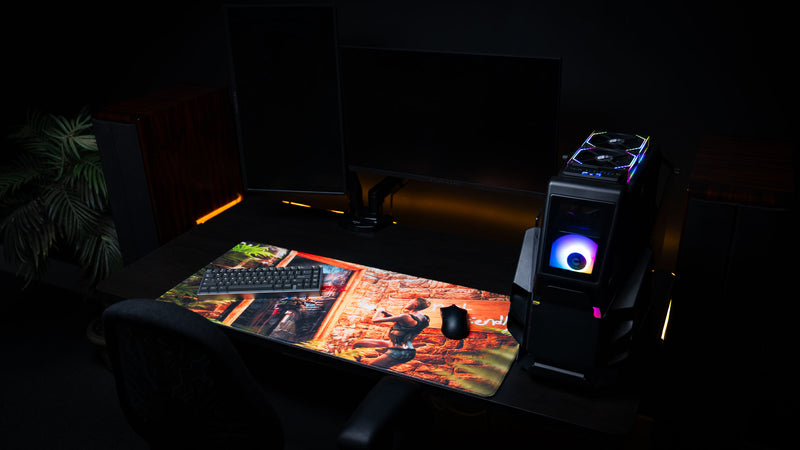 RGB gaming desk setup featuring The Doorcamper / Angle 3 Rust deskmat with mechanical keyboard, gaming mouse, and desktop PC, showcasing the immersive raid artwork across the full extended mouse pad.