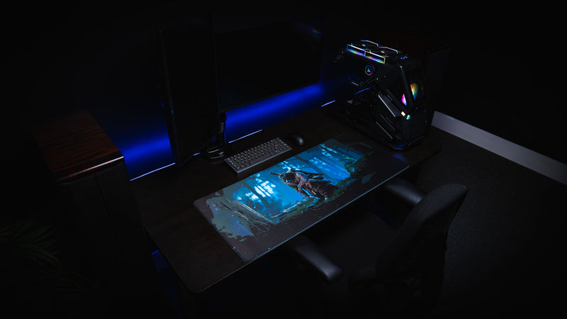 Official Rust Hunted XXL deskmat displayed in a premium gaming room setup, featuring a lone survivor in a moonlit forest on a stitched-edge cloth gaming deskmat.