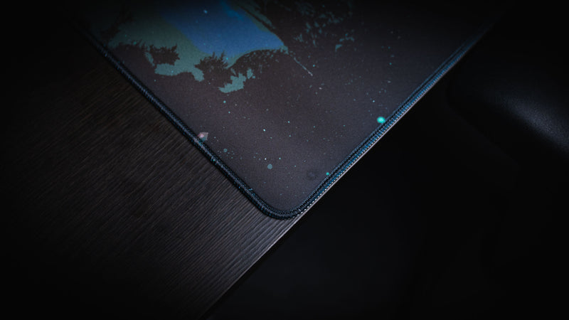 Close-up of the official Rust Hunted XXL deskmat featuring premium stitched edges, smooth cloth surface, and detailed print quality on a gaming desk.
