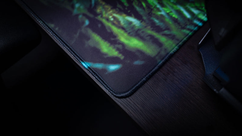 Close-up of The Doorcamper / Angle 1 Rust deskmat showcasing premium stitched edges, durable cloth surface, and vibrant jungle artwork on a high-quality gaming desk mat.