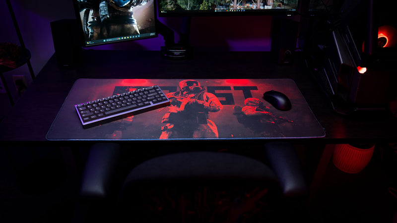 Rust Scientist Trio deskmat displayed with a mechanical keyboard and gaming mouse, showcasing the full artwork, oversized surface, and premium gaming setup.