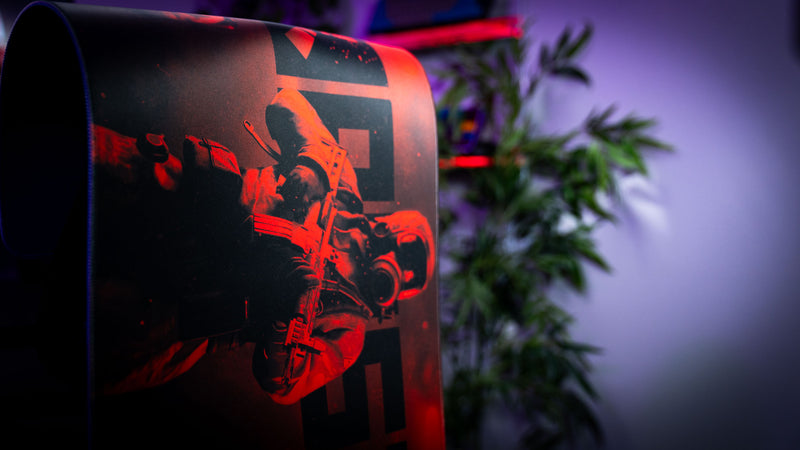 Rolled Rust Scientist Trio deskmat showcasing the premium print quality and flexibility of the desk mat, featuring a scientist character and Rust-themed artwork in red lighting.