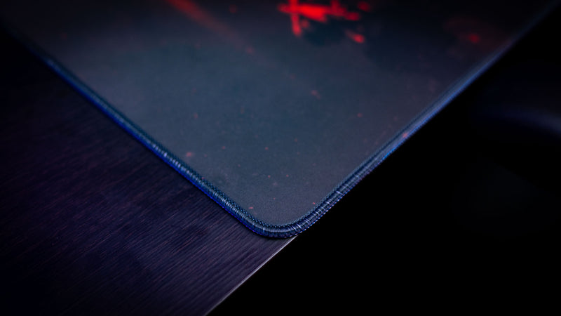 Close-up of the Rust Scientist Trio deskmat corner showcasing premium stitched edges, durable construction, and the smooth gaming surface texture.