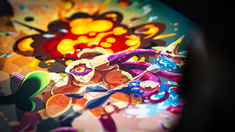 Close-up of the Sedi-mat deskmat by Pokedex Studios highlighting colorful fantasy creatures, explosive magical effects, and crisp high-definition artwork on a premium gaming deskmat.
