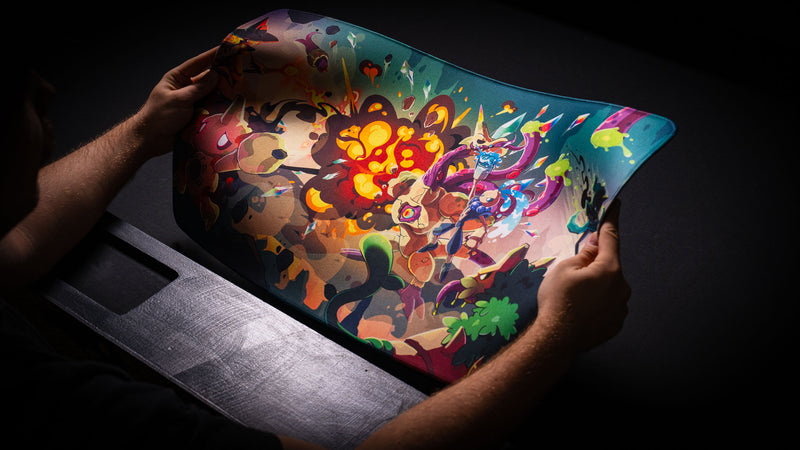 Hands demonstrating the flexibility of the Sedi-mat premium TCG playmat by Pokedex Studios with vibrant fantasy artwork and a durable stitched-edge construction.