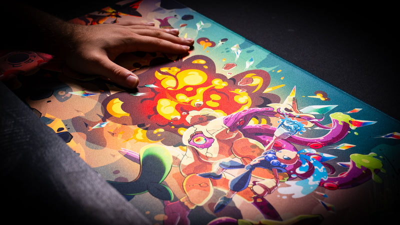 Hand demonstrating the smooth cloth surface of the Sedi-mat premium TCG playmat by Pokedex Studios featuring vibrant fantasy artwork and tournament-ready print quality.