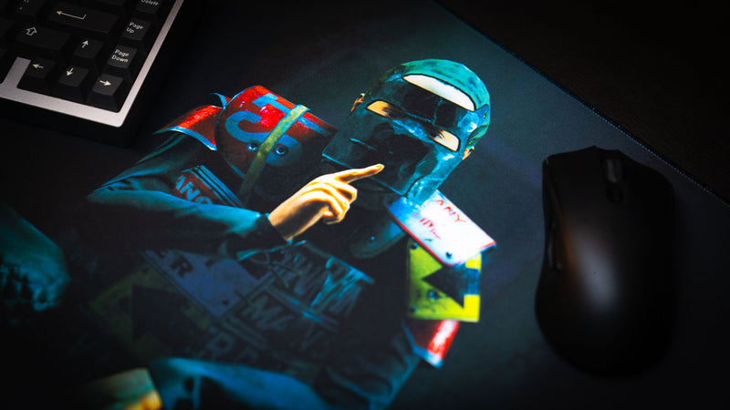 Close-up of the Shh Rust deskmat featuring a masked character making a shushing gesture, with vibrant lighting, detailed artwork, and a premium gaming surface.