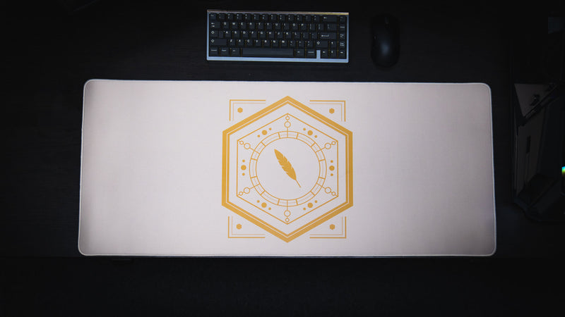 Overhead view of the Feathered Host deskmat on a dark desk with keyboard and mouse