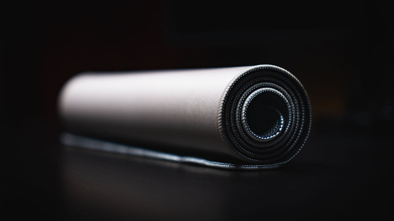 Rolled Feathered Host deskmat viewed from its stitched end