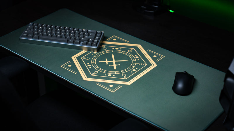 Angled view of House Veridian deskmat with a keyboard and mouse on its green surface