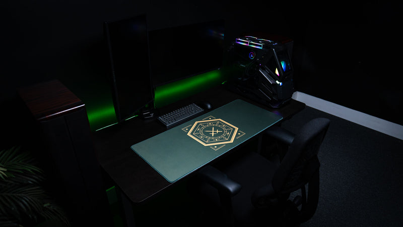 House Veridian deskmat in a dark dual-monitor gaming setup with green lighting