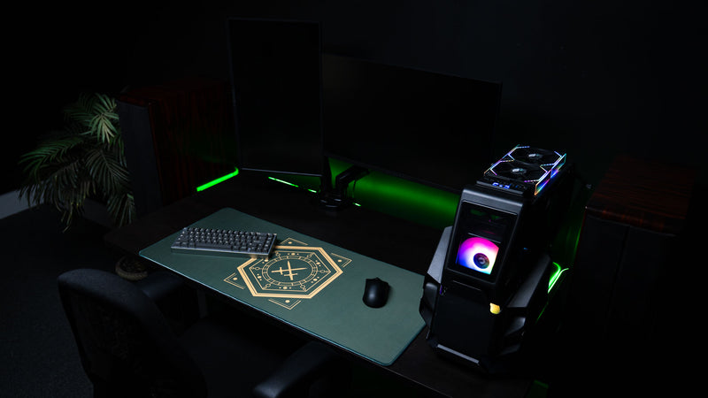 House Veridian deskmat across a gaming desk with monitors and an illuminated PC
