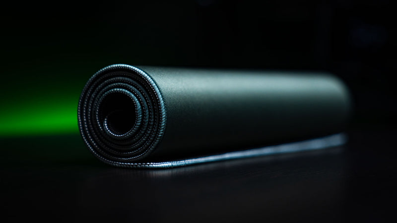 Rolled House Veridian deskmat showing its green fabric and stitched edge