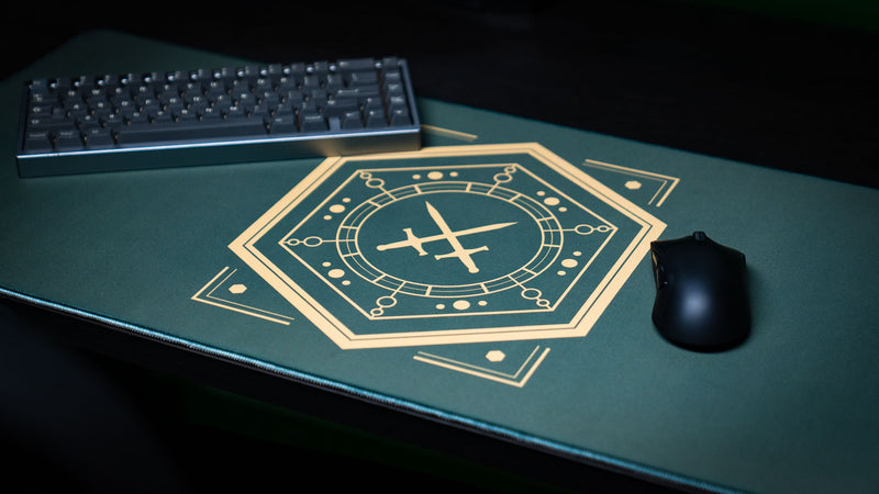Gold House Veridian sigil on a green deskmat with a keyboard above and mouse to the right