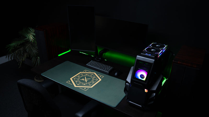 Wide view of House Veridian deskmat in a dark gaming setup with monitors and PC