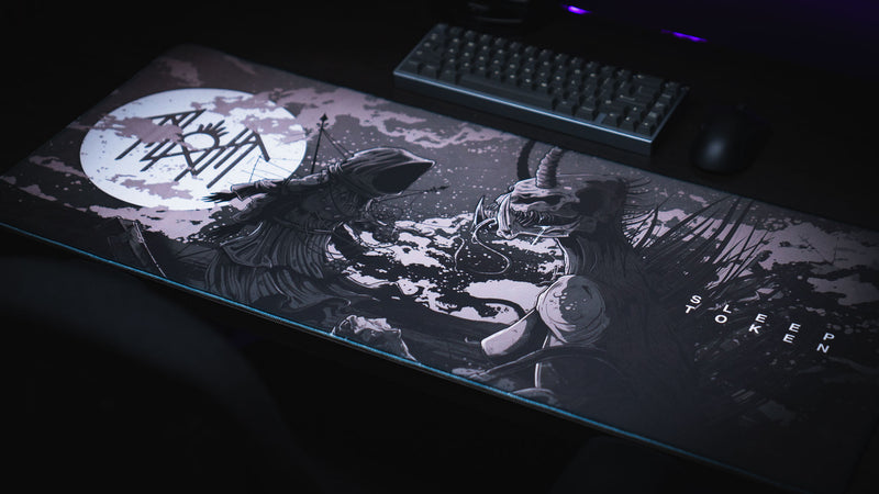 Angled view of The Battle deskmat artwork with a keyboard above it