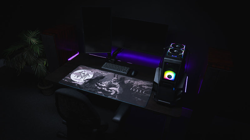 The Battle deskmat in a dual-monitor gaming setup with purple lights and an RGB PC