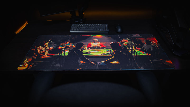 Wide desktop view of the Sleight of Hand Rust gaming deskmat featuring survivors gathered around a poker table in a dimly lit cabin.