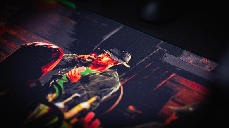 Close-up of the Sleight of Hand Rust gaming deskmat featuring a survivor smoking while holding poker cards during an underground cabin poker game.