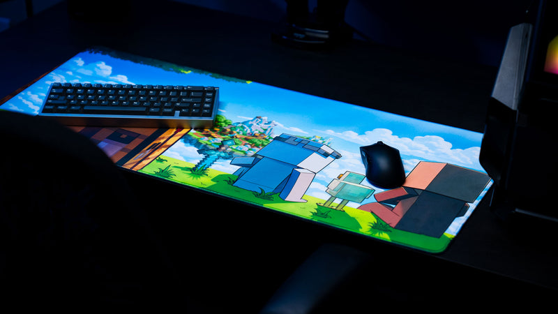 Something Like That creator collaboration deskmat displayed in a gaming setup featuring colorful block-style characters, floating island artwork, keyboard, and mouse.