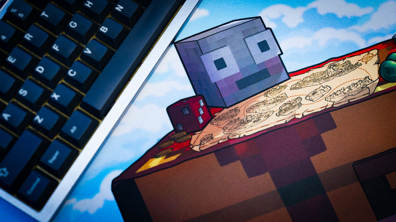 Close-up of the map table and adventure-themed artwork featured on the Something Like That creator collaboration deskmat beside a mechanical keyboard.