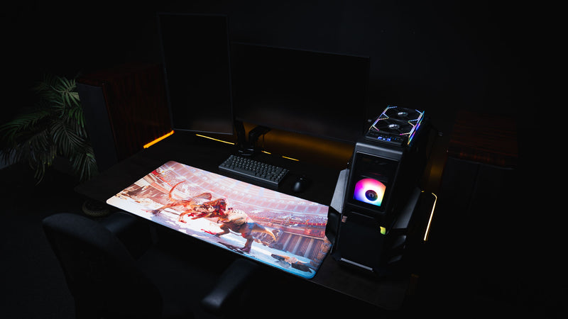 Wide gaming setup featuring The Spinosaurus Chompers deskmat by Keenling with a dramatic dinosaur battle between a Spinosaurus and Triceratops in a Roman gladiator arena.