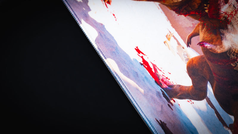 Close-up of The Spinosaurus Chompers deskmat by Keenling highlighting the premium stitched edge and detailed artwork of a dinosaur battle in a Roman gladiator arena.