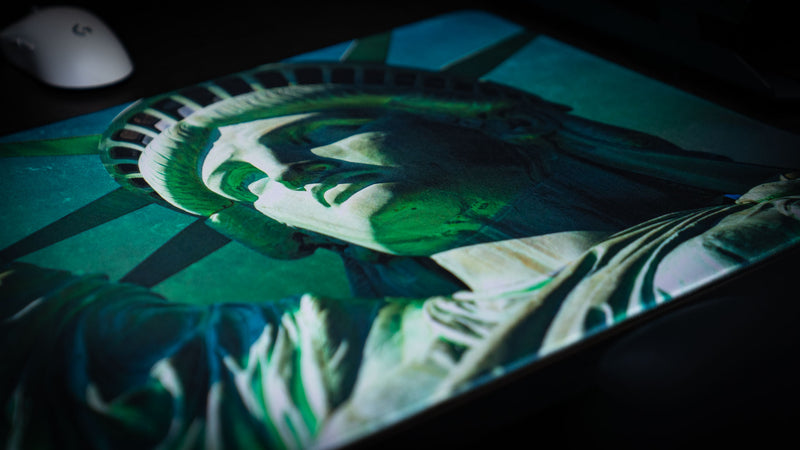Close-up detail of the Statue of Liberty artwork printed on the America 250 deskmat, showcasing high-definition color, intricate textures, and premium stitched-edge construction.