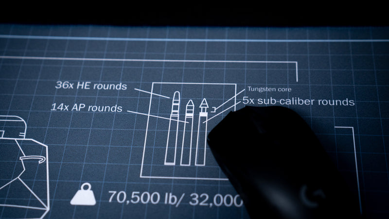 Close-up of the Jimarkus T-34 Schematic deskmat showcasing blueprint ammunition diagrams, shell specifications, and precision technical artwork with a gaming mouse on the surface.