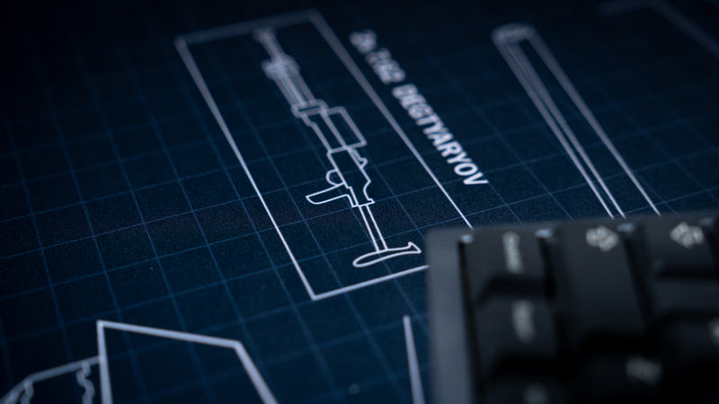 Close-up of the Jimarkus T-34 Schematic deskmat highlighting the Degtyaryov machine gun blueprint and detailed technical grid artwork beside a mechanical keyboard.