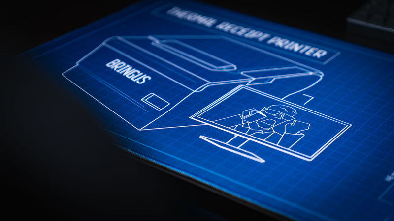 Close-up product shot of the Thermal Receipt Printer blueprint deskmat by Bringus, highlighting the technical printer illustration, blueprint grid design, and premium stitched-edge extended gaming mouse pad.