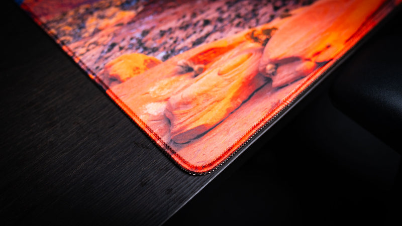 Close-up of the Trail to Delicate Arch deskmat highlighting premium stitched edges, vibrant Arches National Park photography, and durable gaming surface.