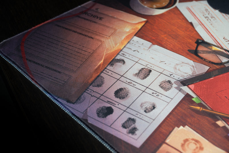 Close-up of fingerprint records and an archive folder printed on the Ty Notts desk mat