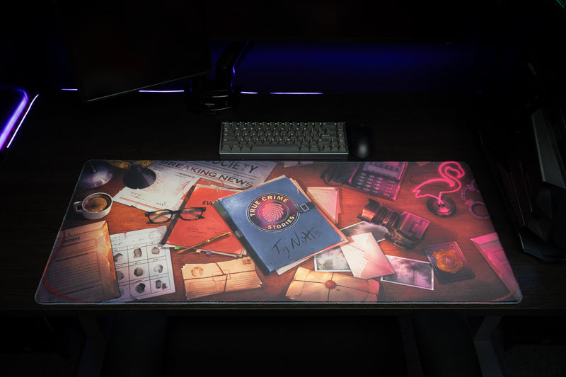 Front view of the Detective Perspective desk mat laid flat beneath a keyboard and monitors