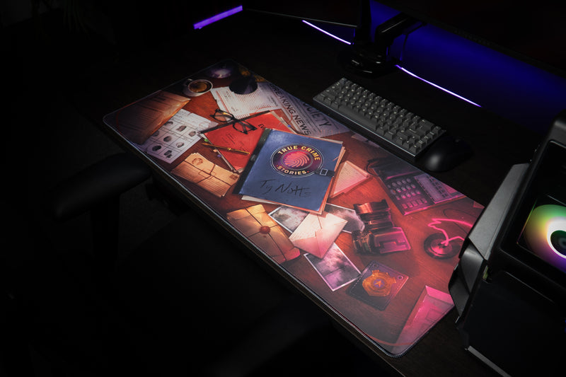 Right-angled view of the Ty Notts desk mat showing the true-crime case file and flamingo lamp artwork