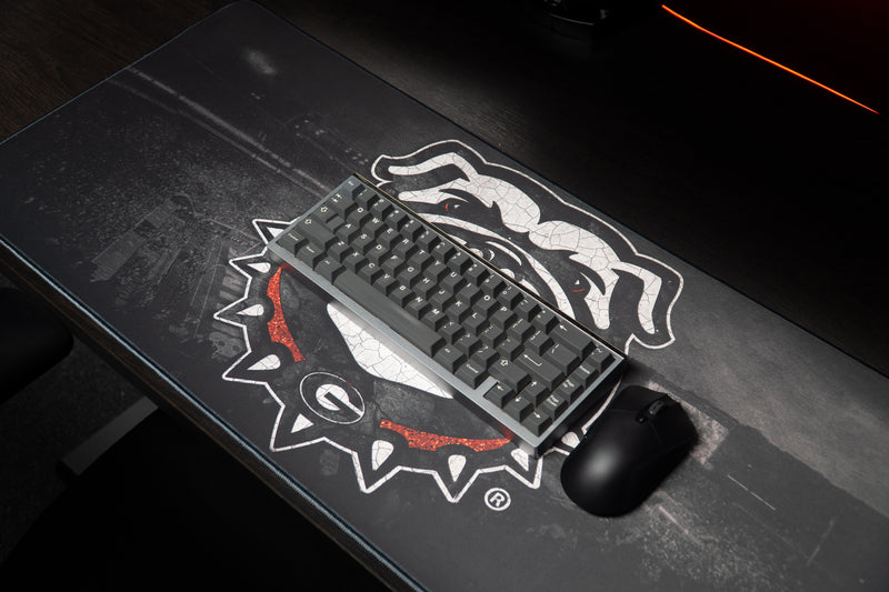 Keyboard and mouse resting on the Georgia Bulldogs Home Turf deskmat.