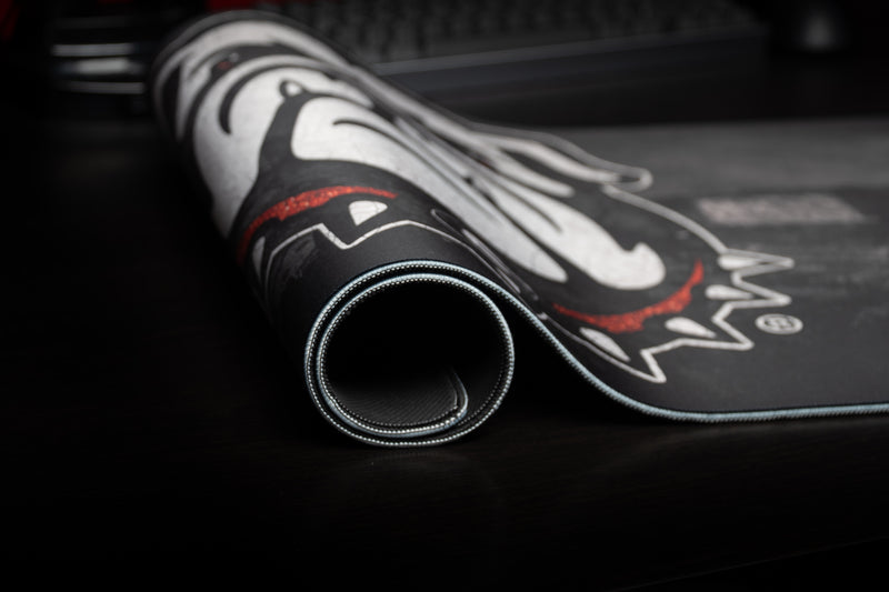 Rolled edge of the Georgia Bulldogs Home Turf deskmat showing the bulldog and stitched border.