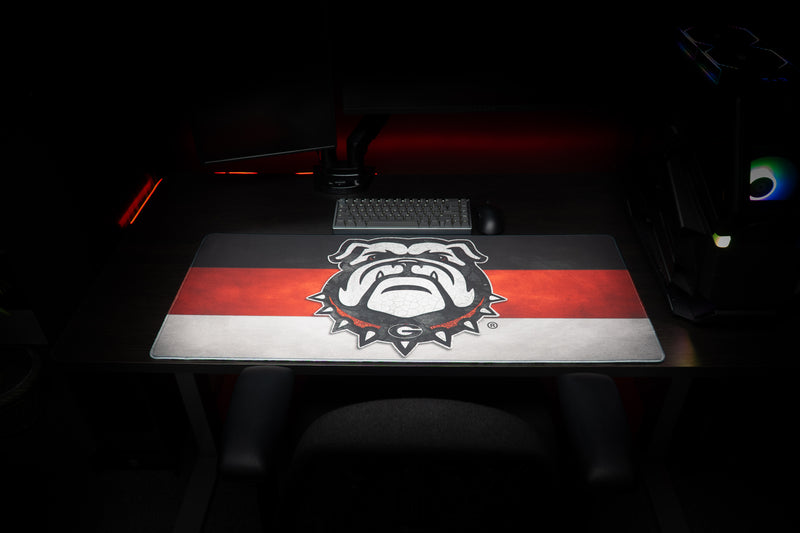 Front view of the Georgia Bulldog's Pride deskmat beneath a keyboard.
