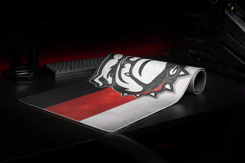 Georgia Bulldog's Pride deskmat partly rolled on a desktop.