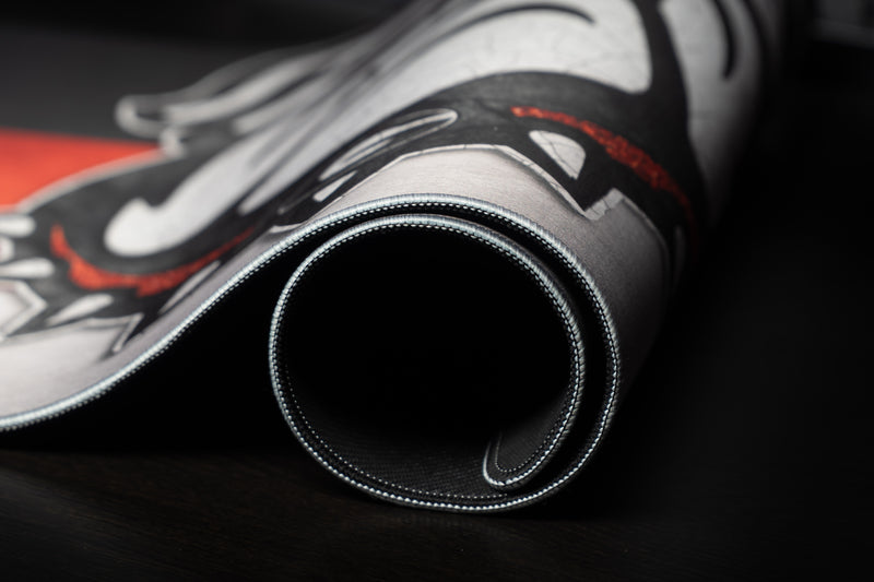 Rolled edge of the Georgia Bulldog's Pride deskmat showing the mascot and stitched border.