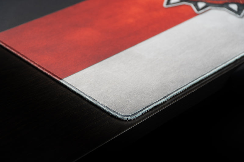 Close-up of the stitched corner and red-and-white stripes on the Georgia Bulldog's Pride deskmat.